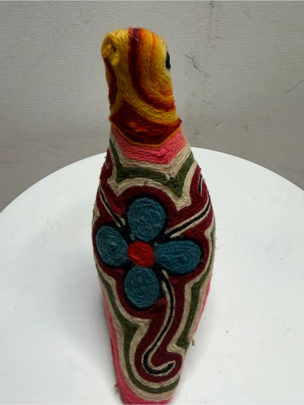 traditional bird figurine in the Huichol yarn art style